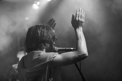 Rear view of singer singing on stage