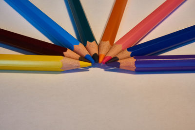 High angle view of multi colored pencils on white table