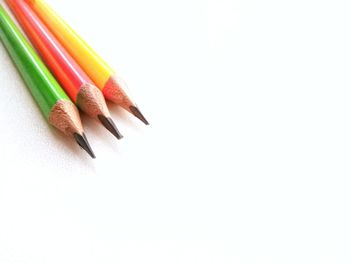 Close-up of colored pencils against white background