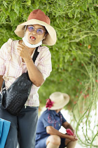 Midsection of woman holding hat