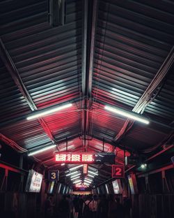 People standing at illuminated subway station