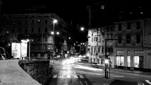 Light trails on road in city at night