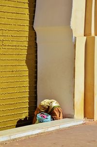 Woman sitting by mosque door