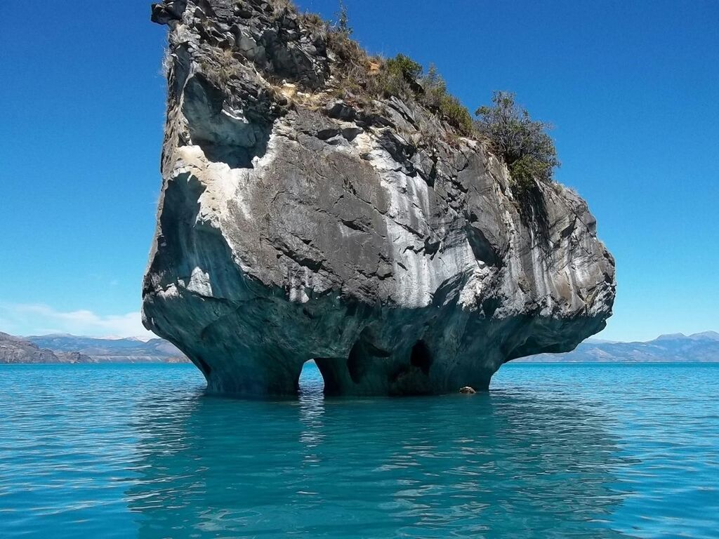 water, blue, sea, clear sky, rock formation, waterfront, scenics, tranquil scene, tranquility, beauty in nature, rock - object, nature, mountain, cliff, idyllic, rippled, sunlight, sky, day, rock