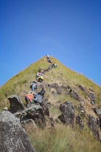 People riding motorcycle on rock