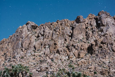 Low angle view of rock formations against sky