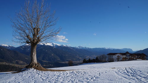 Scenic view of snow covered mountains against sky