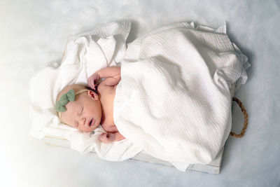 High angle view of baby boy sleeping on bed