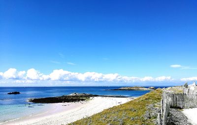 Scenic view of beach against blue sky