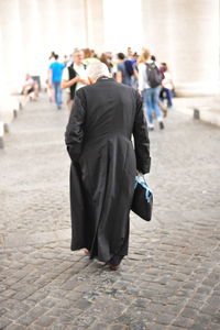 Rear view of people walking outdoors