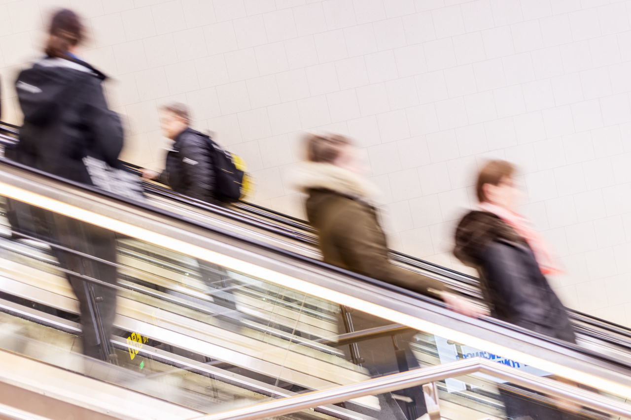 BLURRED MOTION OF PEOPLE ON ESCALATOR