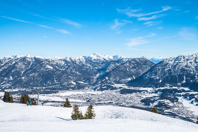 Scenic view of snowcapped mountains against blue sky