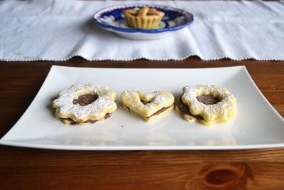 Cookies in plate on wooden table