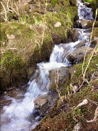 Scenic view of river flowing through rocks