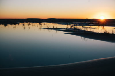 Scenic view of lake against sky during sunset
