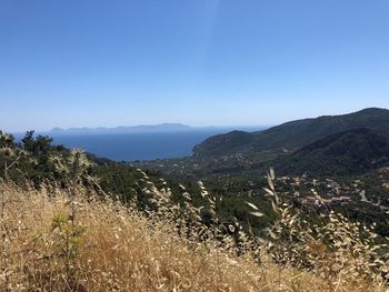 Scenic view of mountains against clear blue sky