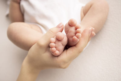 Low section of baby on bed