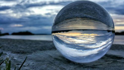 Reflection of river on crystal ball at sunset