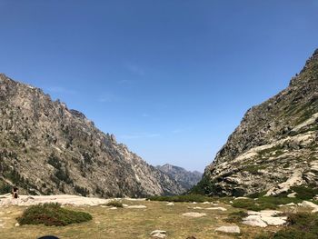 Scenic view of mountains against clear blue sky