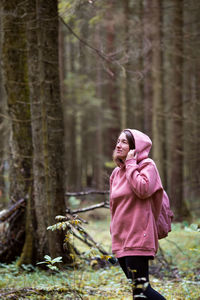 Woman standing in forest