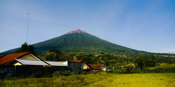 Houses on mountain against sky