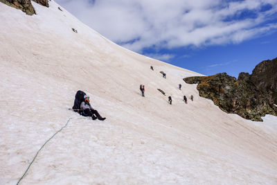 People on mountain road against sky