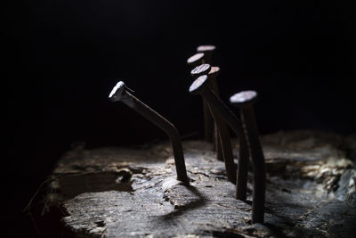 Close-up of empty wooden table against black background