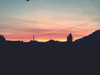 Silhouette landscape against sky during sunset