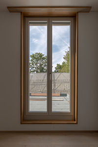 Trees seen through window of house