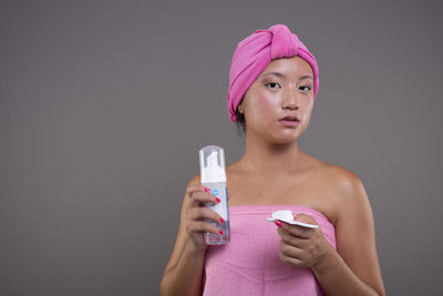 Portrait of young woman drinking glass