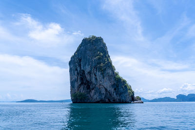 Rock formation in sea against sky