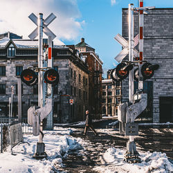 Buildings in city against sky during winter