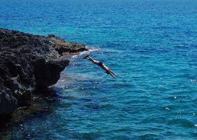 Boy jumping in sea