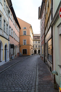 Empty alley amidst houses in town