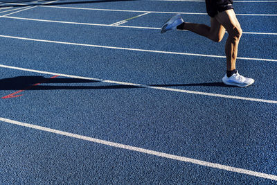 Mature athlete running on track