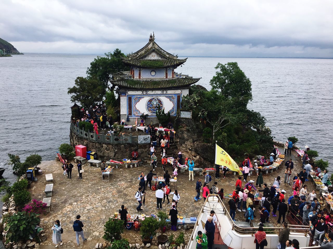 large group of people, water, group of people, crowd, built structure, architecture, real people, men, sky, cloud - sky, building exterior, adult, women, nature, religion, sea, day, belief, travel destinations, outdoors, visit