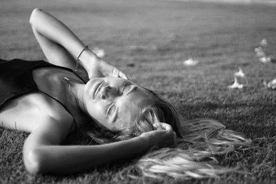 Low section of woman lying on field