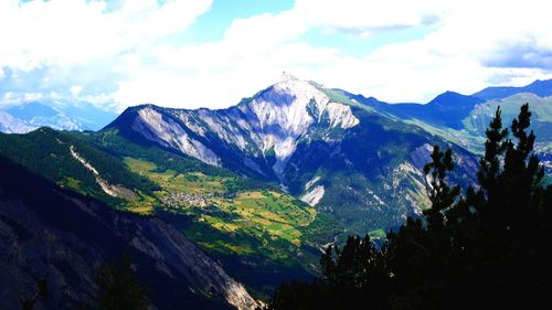 Scenic view of mountains against cloudy sky