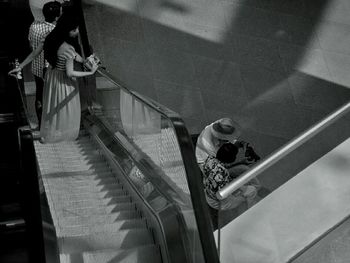 Woman standing on escalator