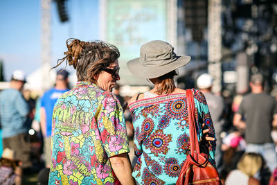Rear view of couple holding hands on bridge