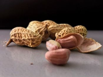 Close-up of fruits on table against black background