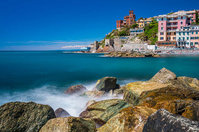 Panoramic view of sea and buildings against sky