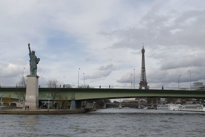 View of bridge over river against cloudy sky