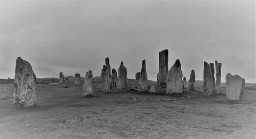 Megaliths on land against sky
