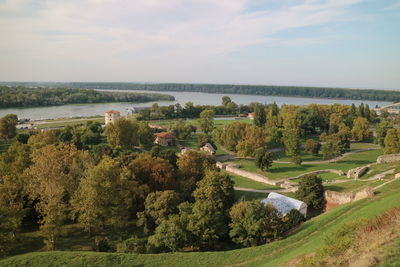 High angle view of townscape by sea against sky