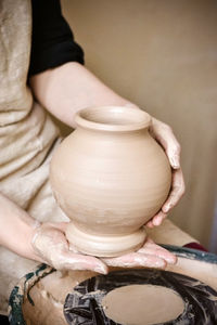 Potter holds just hired by pitcher. ceramic skills. sculptor sculpts products from white clay. 