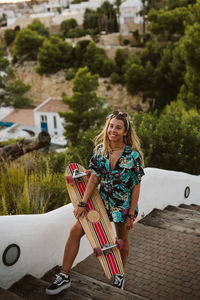 Young happy female with long board skate in moraira