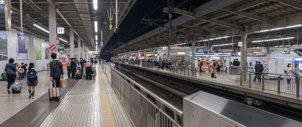 People waiting at railroad station platform