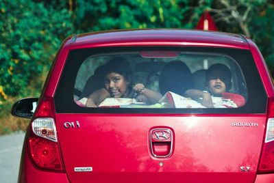 Portrait of a young woman sitting in car