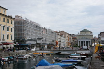 Boats in river with buildings in background